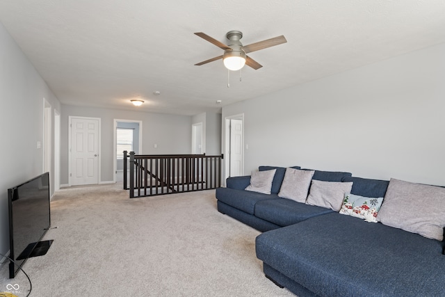 carpeted living room with ceiling fan