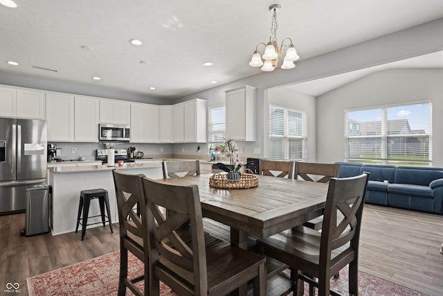 10797 Walden Ln, Brownsburg, IN 46112 - dining room featuring a chandelier, wood finished floors, recessed lighting, and lofted ceiling
