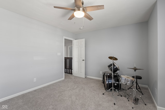 miscellaneous room with ceiling fan and light carpet