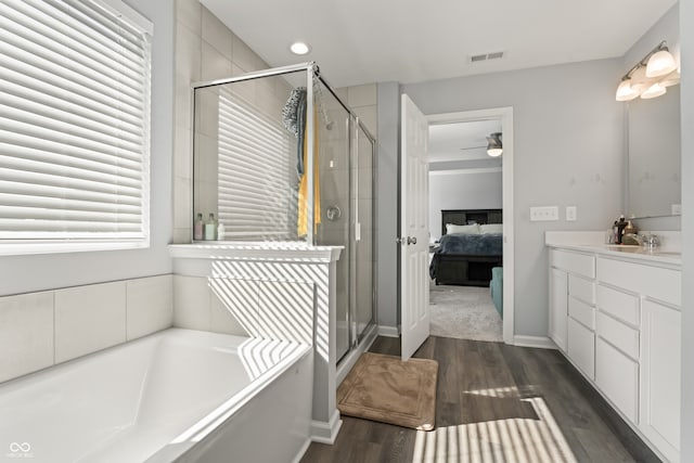 bathroom with separate shower and tub, ceiling fan, hardwood / wood-style floors, and vanity