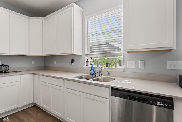 kitchen featuring stainless steel dishwasher, white cabinetry, sink, and dark wood-type flooring