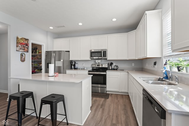 kitchen featuring white cabinets, plenty of natural light, and appliances with stainless steel finishes