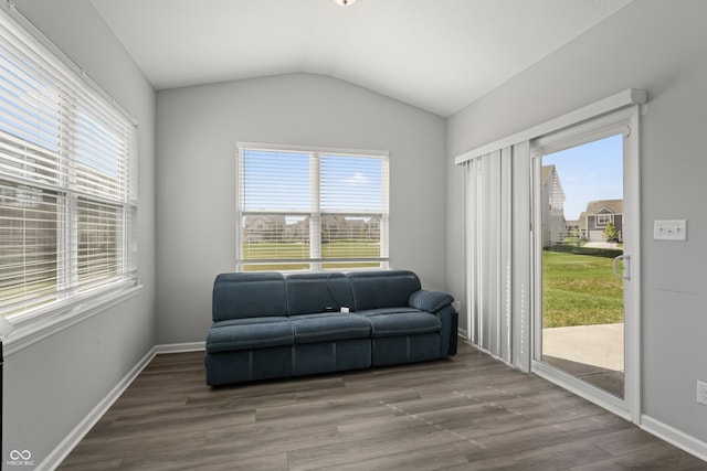 sitting room with hardwood / wood-style floors, a healthy amount of sunlight, and lofted ceiling