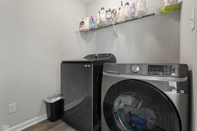 washroom with hardwood / wood-style floors and separate washer and dryer