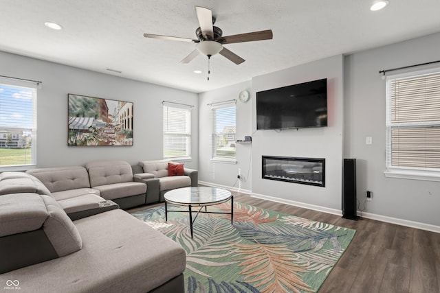 10797 Walden Ln, Brownsburg, IN 46112 - living area featuring wood finished floors, ceiling fan, baseboards, recessed lighting, and a glass covered fireplace