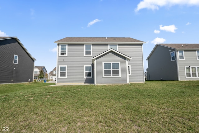 rear view of house with a yard