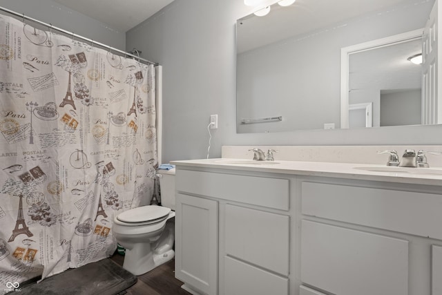 10797 Walden Ln, Brownsburg, IN 46112 - full bathroom with double vanity, toilet, wood finished floors, and a shower with curtain