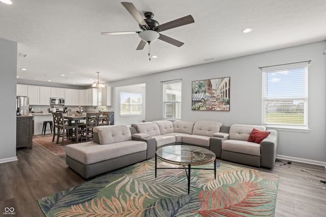 living room with a textured ceiling, hardwood / wood-style flooring, and plenty of natural light