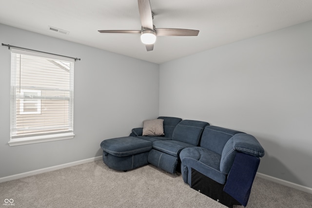 carpeted living room featuring ceiling fan