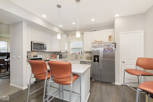 kitchen featuring white cabinetry, a healthy amount of sunlight, and appliances with stainless steel finishes