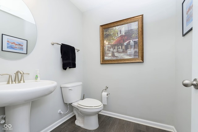 bathroom with sink, wood-type flooring, and toilet