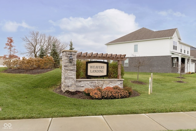 community / neighborhood sign featuring a yard