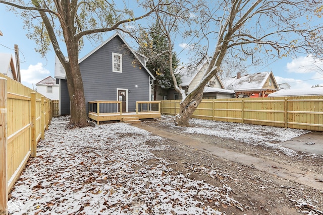 snow covered property with a wooden deck