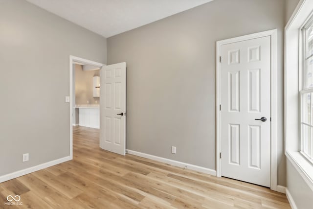 unfurnished bedroom with light wood-type flooring