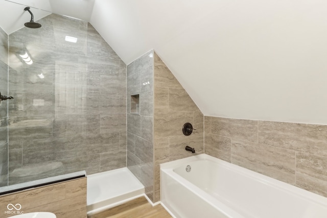 bathroom featuring separate shower and tub, wood-type flooring, and vaulted ceiling