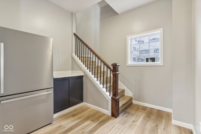 stairway with hardwood / wood-style floors