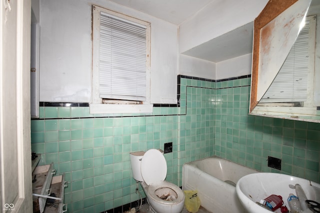 bathroom featuring a tub, tile walls, and toilet