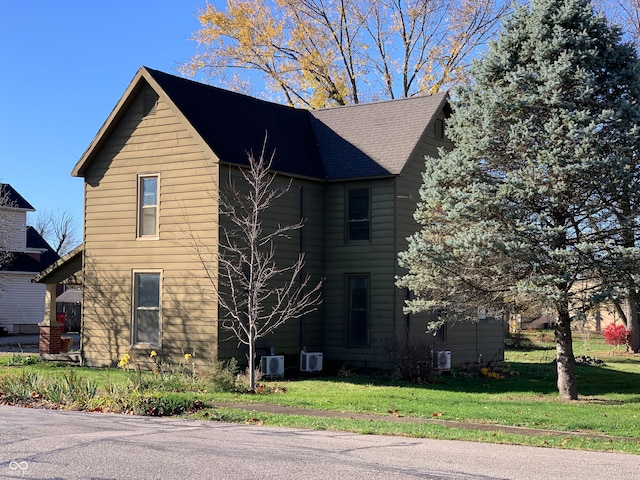 view of home's exterior with ac unit and a lawn