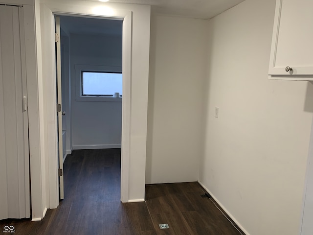 hallway with dark wood-type flooring