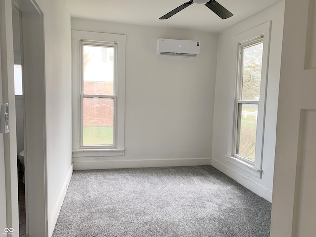 unfurnished room featuring carpet flooring, a wall unit AC, and ceiling fan