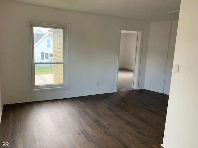 spare room with dark wood-type flooring