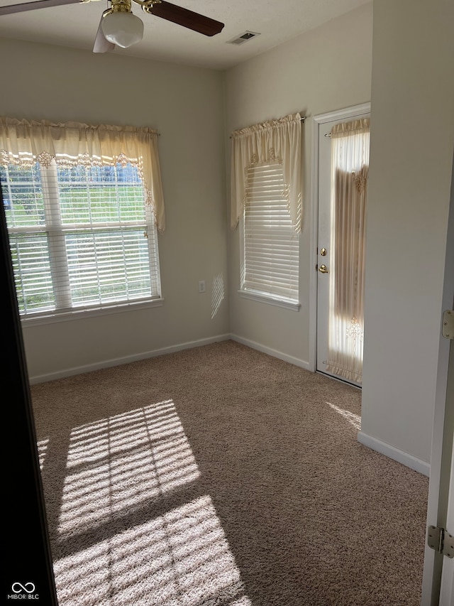 carpeted empty room featuring ceiling fan