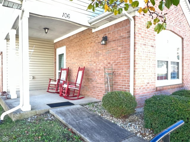 view of exterior entry with a porch