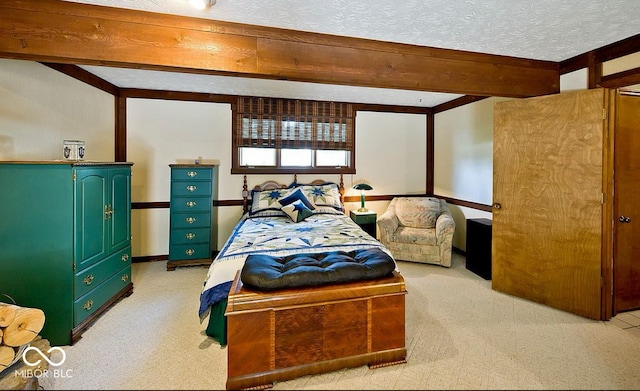 carpeted bedroom featuring beam ceiling and a textured ceiling