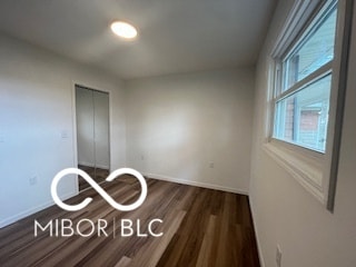 unfurnished bedroom featuring dark hardwood / wood-style flooring