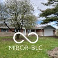 view of front of property with a front yard and a garage