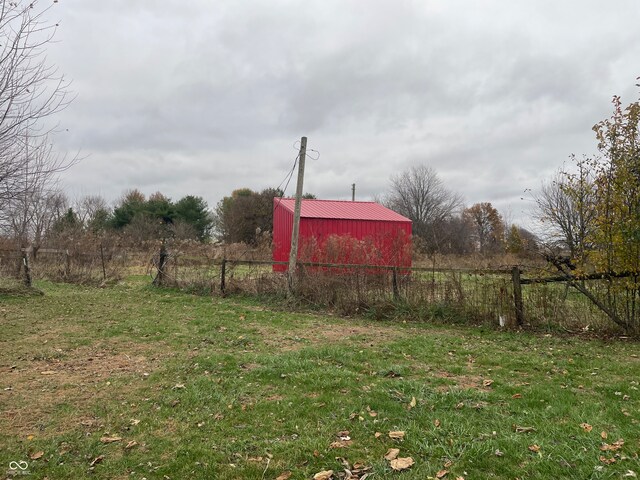 view of yard featuring an outbuilding and a rural view