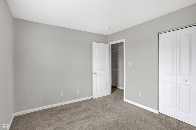 unfurnished bedroom with carpet floors and a closet