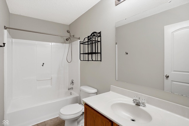 full bathroom featuring vanity, tile patterned floors, washtub / shower combination, toilet, and a textured ceiling