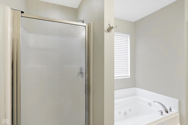 bathroom featuring a wealth of natural light and shower with separate bathtub