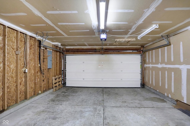 garage featuring a garage door opener and electric panel