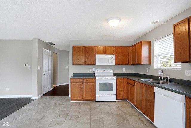 kitchen featuring light wood-type flooring, white appliances, and sink