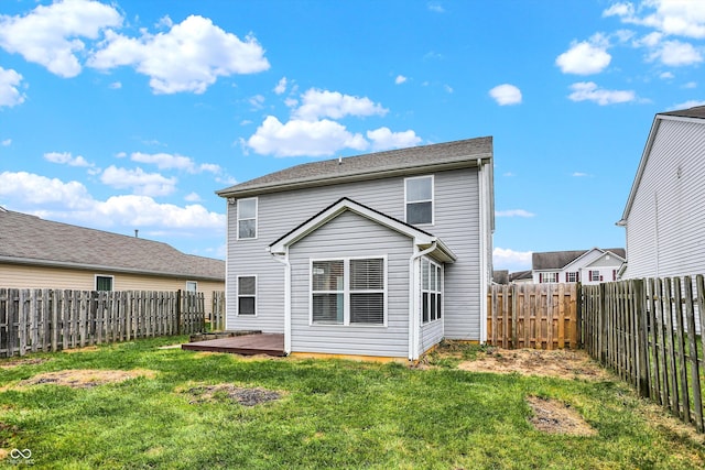 back of property featuring a yard and a deck