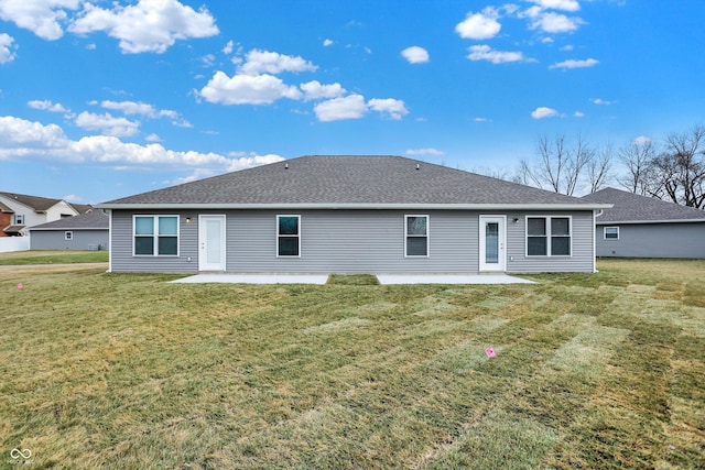 rear view of house featuring a yard and a patio