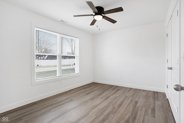 spare room featuring ceiling fan and light hardwood / wood-style floors