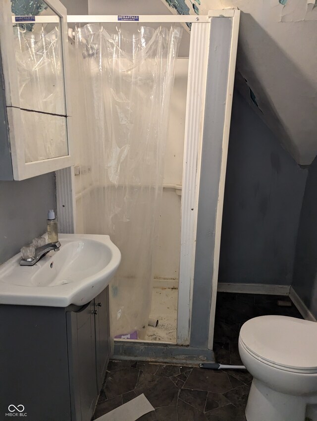 bathroom with a shower, vanity, toilet, and tile patterned flooring