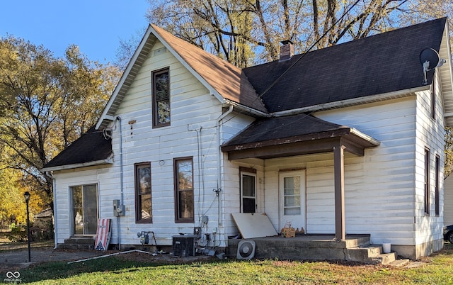 view of front facade with central air condition unit and a front yard