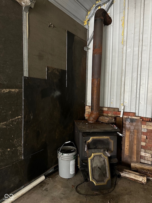 interior details with a wood stove and concrete floors