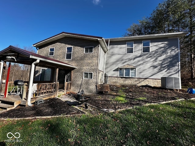 back of property with covered porch and central air condition unit