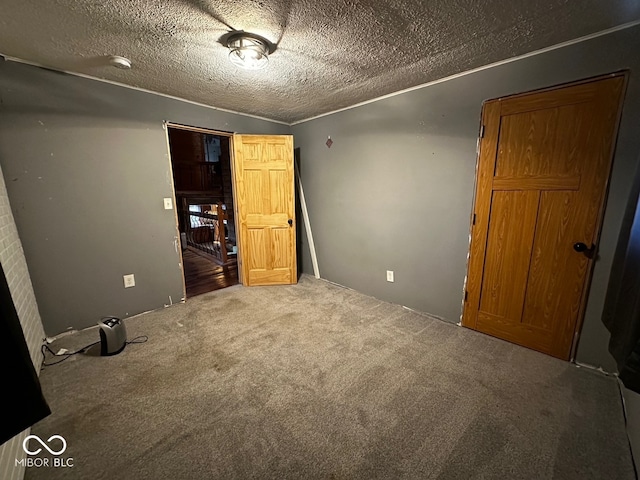 unfurnished bedroom with carpet flooring and a textured ceiling