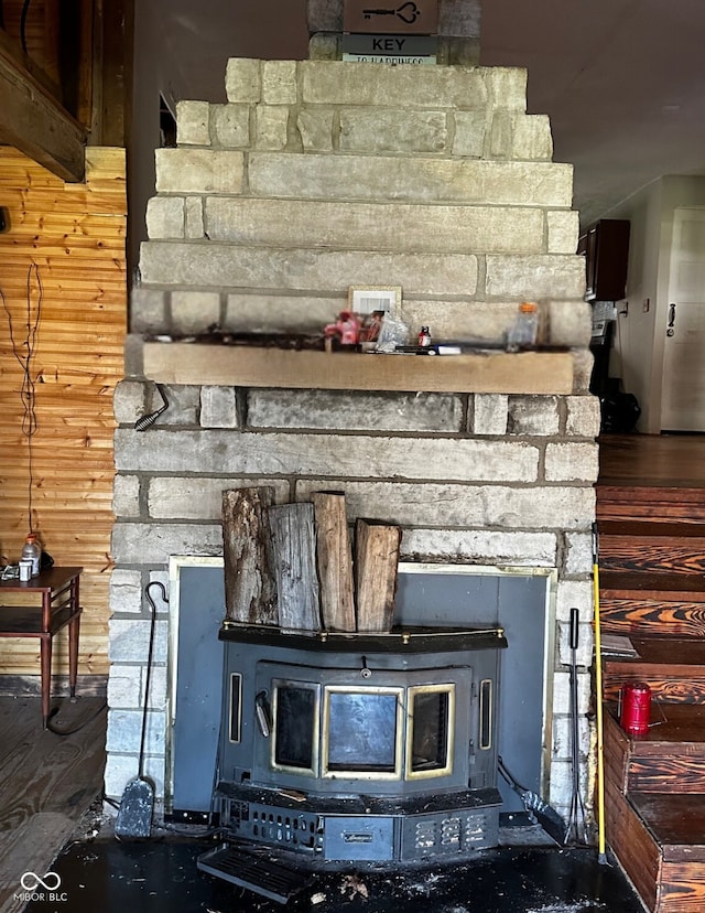 details with a wood stove and wood walls