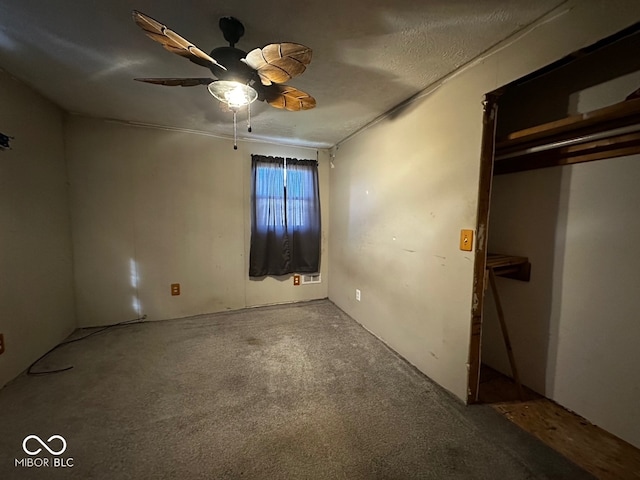 unfurnished bedroom with ceiling fan, carpet floors, and a textured ceiling