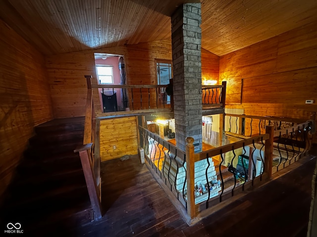 interior space with dark hardwood / wood-style floors, wood walls, lofted ceiling, and wooden ceiling