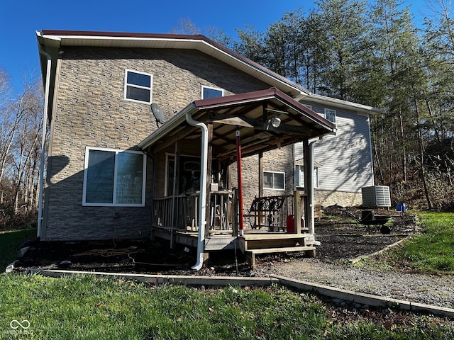 back of house with central AC unit and covered porch