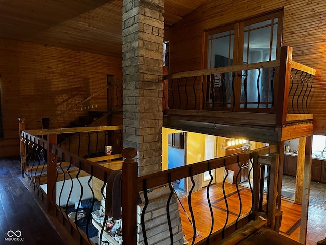 stairs with wooden ceiling, wood-type flooring, lofted ceiling, and decorative columns