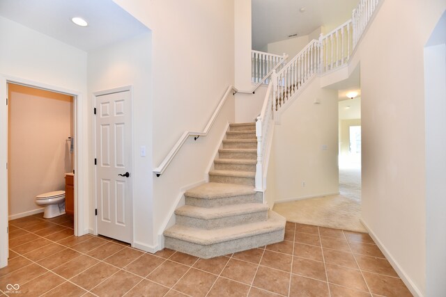 stairs featuring carpet flooring